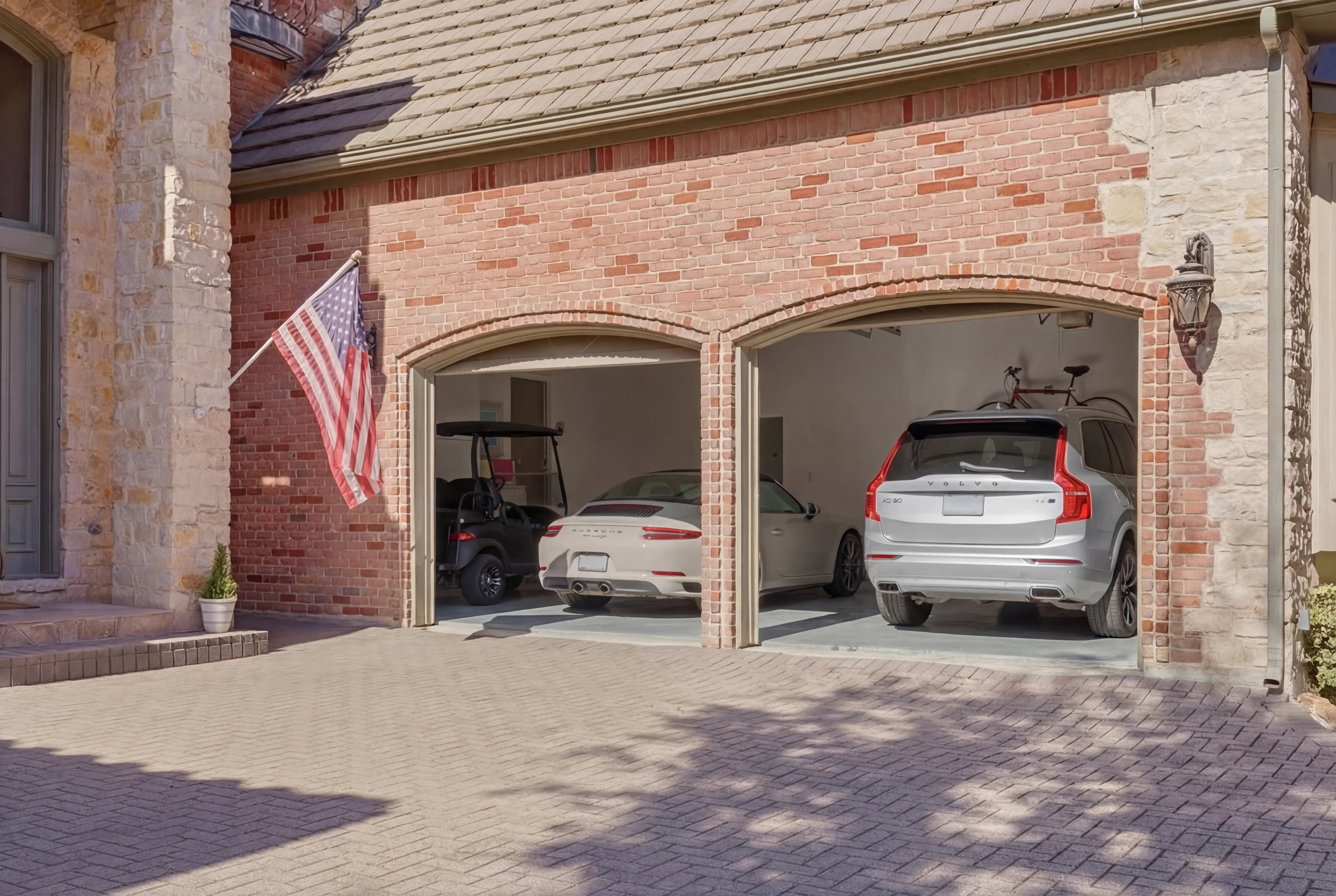 Oversized 2.5-car garage with decorative stone archway